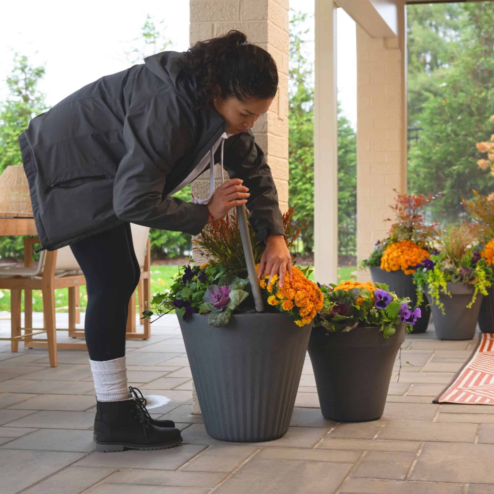 Woman placing the trudrop insert in the fold planter and setting the TruDrop indicator