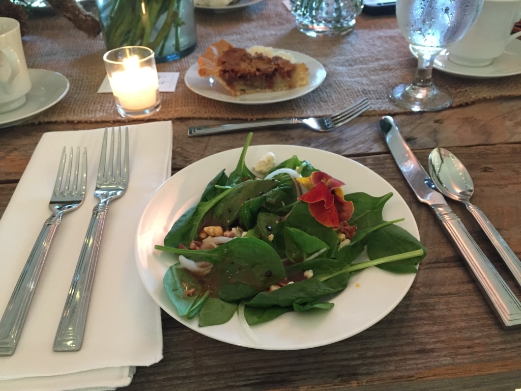 Dinner plate with salad on a table.